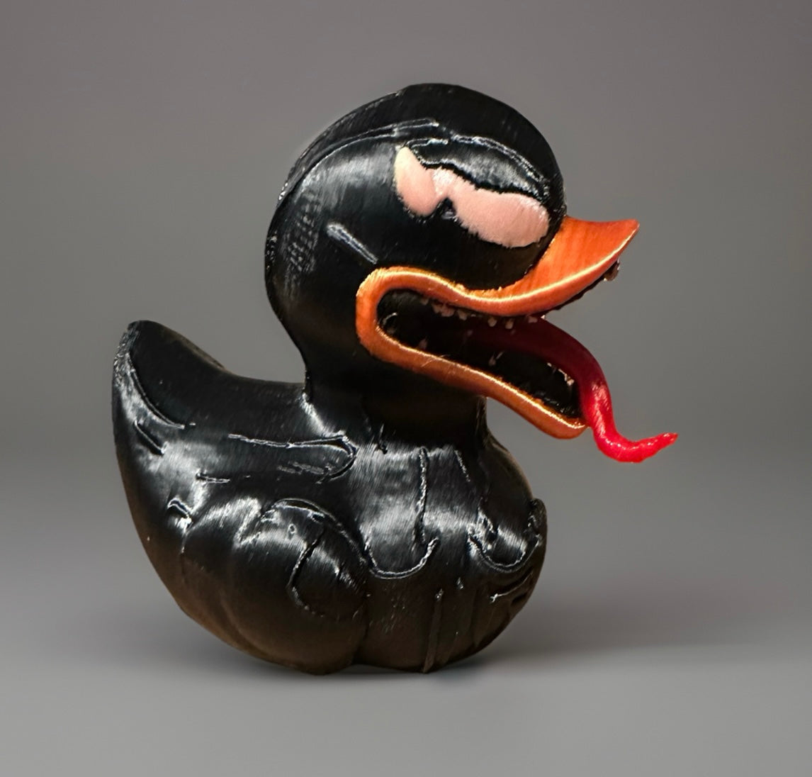 3D printed Venom duck in black with orange beak and red tongue from Reed’s Rubber Ducks and Sensory Shop