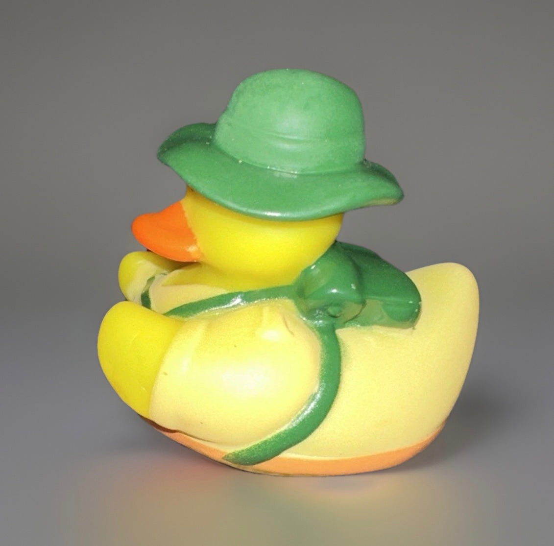 Yellow camper rubber duck collectible wearing a green hat and backpack by Reeds Rubber Ducks