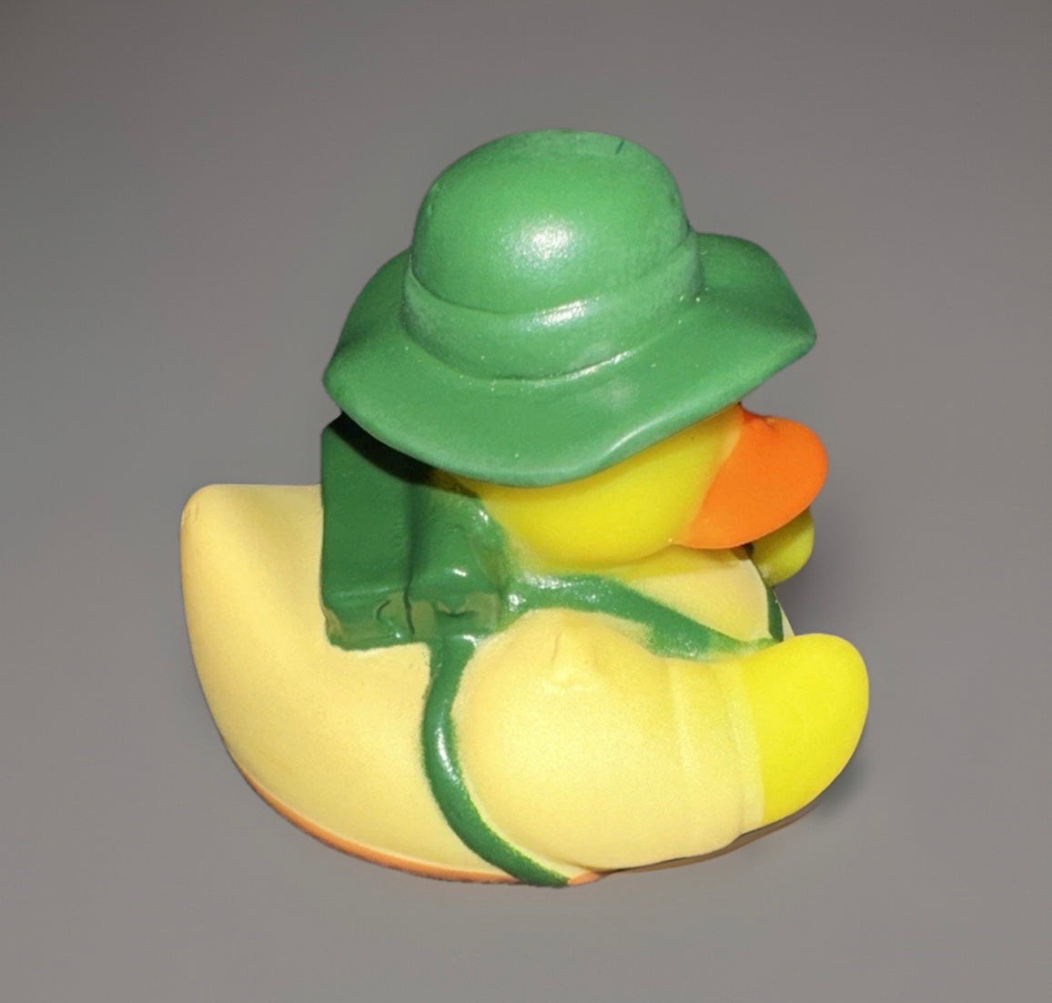 Camper rubber duck collectible wearing a green hat and backpack from Reed’s Rubber Ducks and Sensory Shop