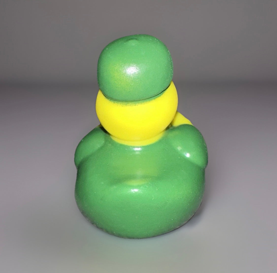 Rear view of campfire rubber duck wearing a green hat and coat from Reed’s Rubber Ducks and Sensory Shop