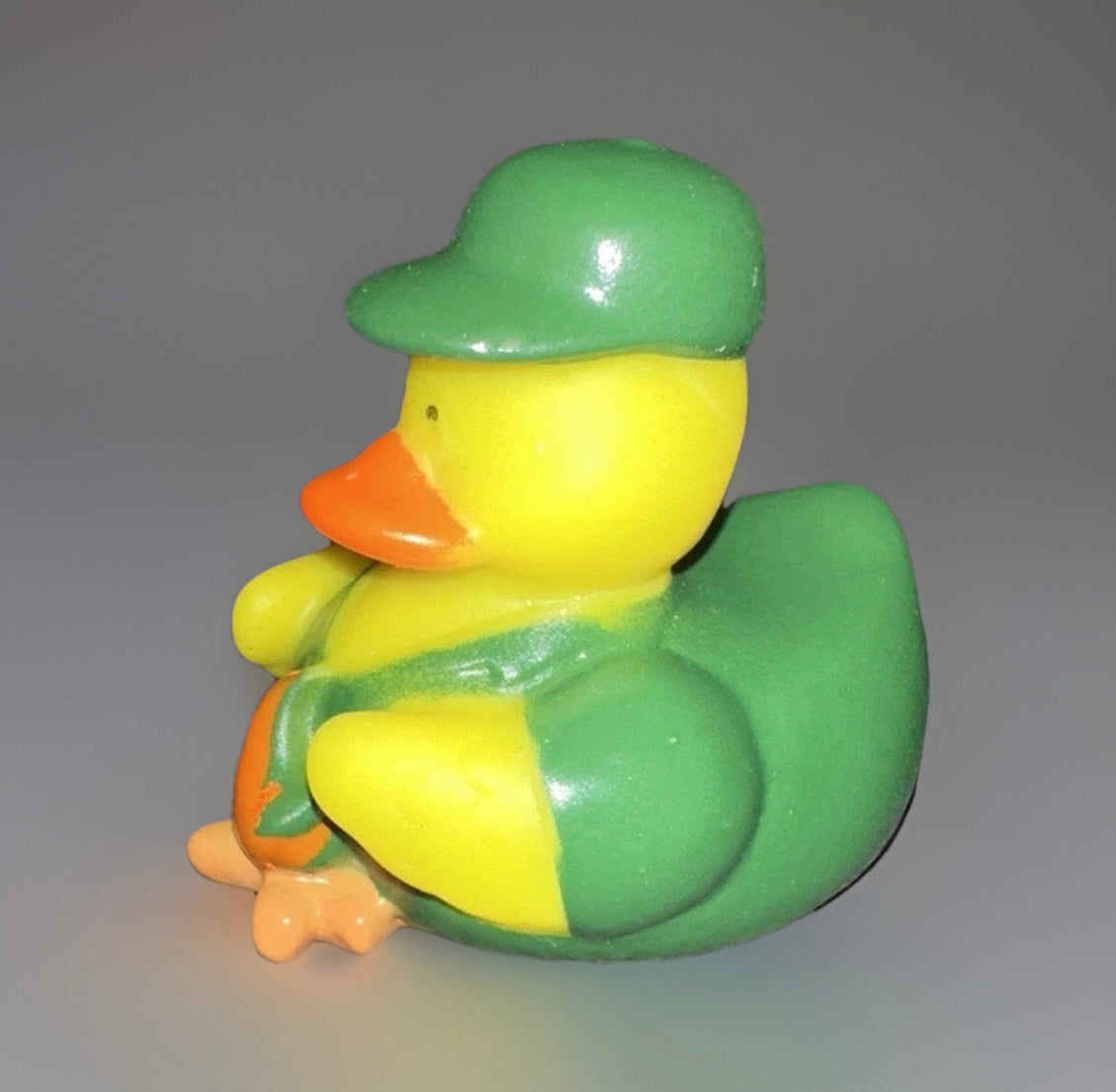 Campfire rubber duck wearing a green hat and jacket with orange beak and feet