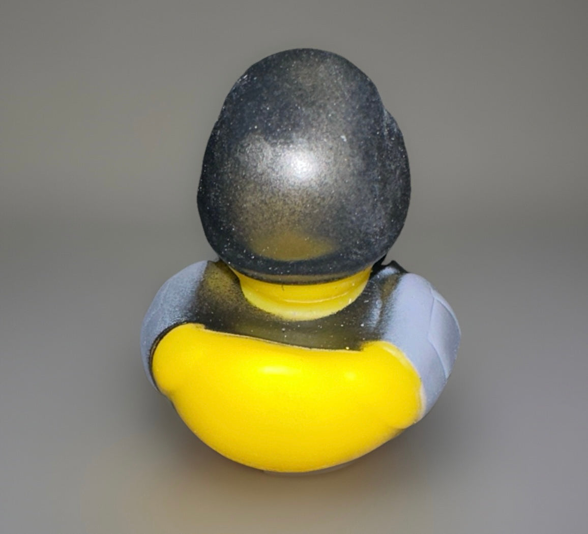Yellow combat rubber duck wearing black and gray tactical helmet and armor from Reed’s Rubber Ducks and Sensory Shop