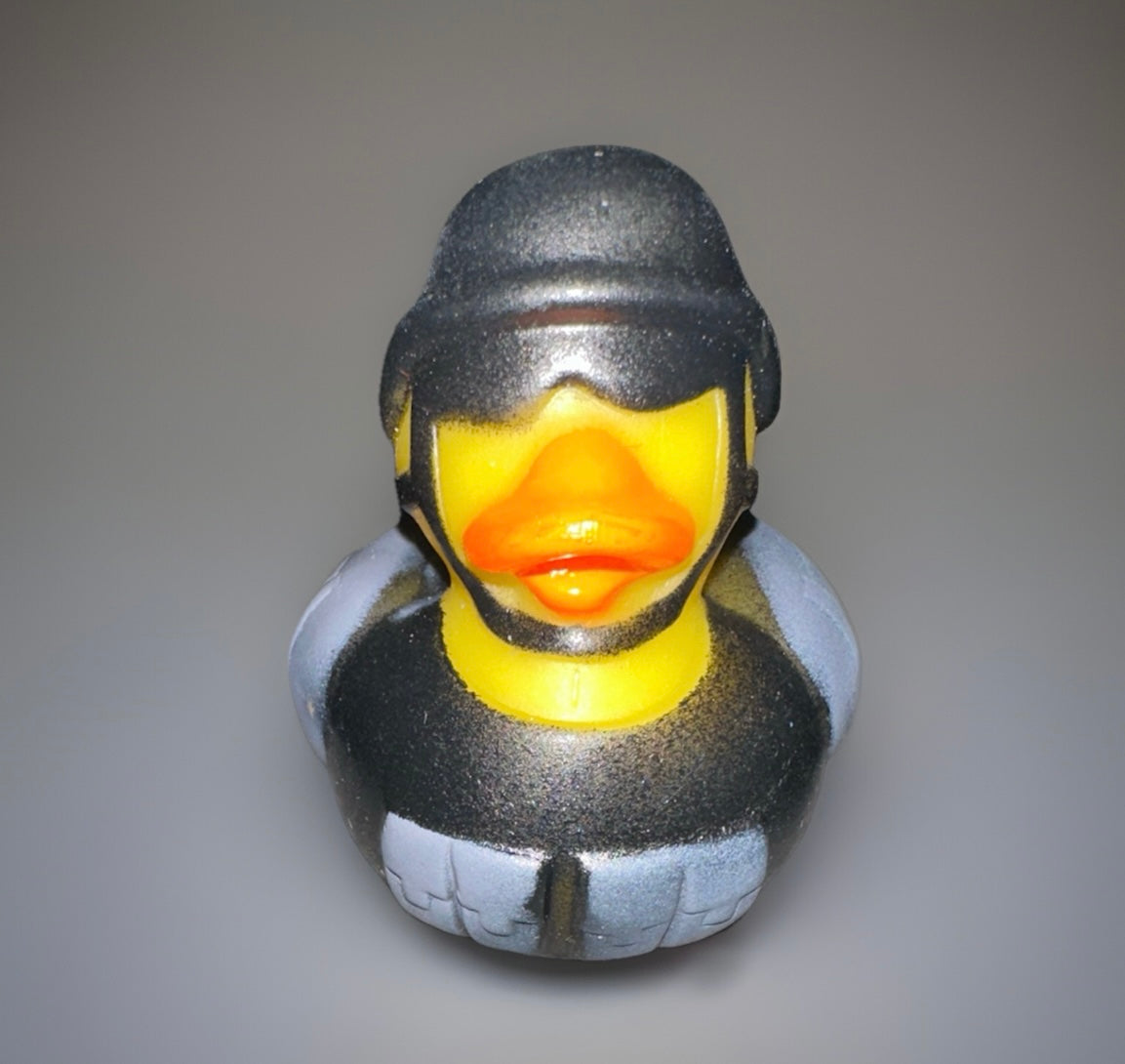 Combat rubber duck wearing black tactical helmet and armor by Reed’s Rubber Ducks and Sensory Shop