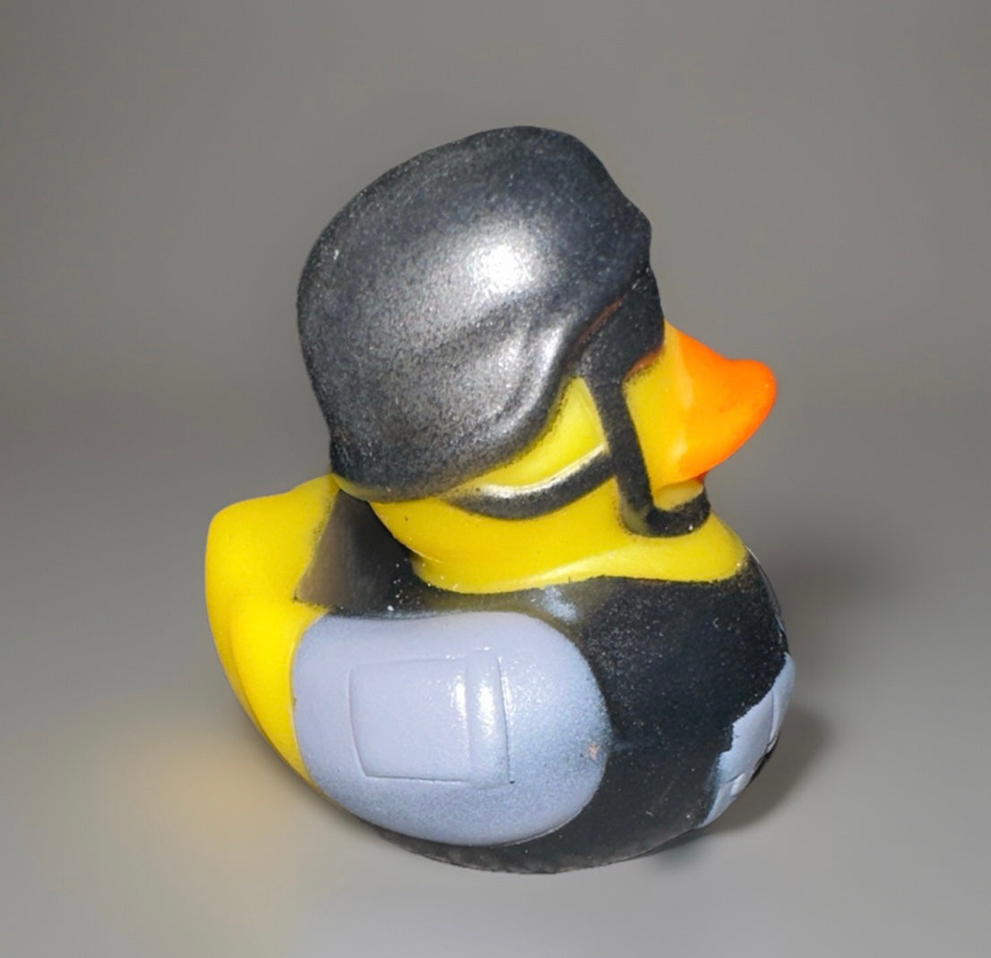 Combat rubber duck wearing black helmet and protective gear from Reeds Rubber Ducks and Sensory Shop
