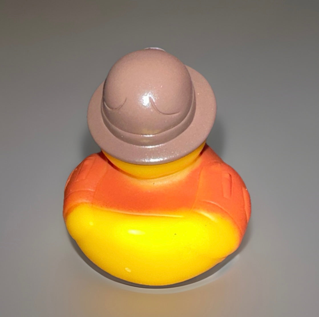 Rear view of deputy rubber duck toy wearing brown hat and orange uniform from Reed’s Rubber Ducks and Sensory Shop