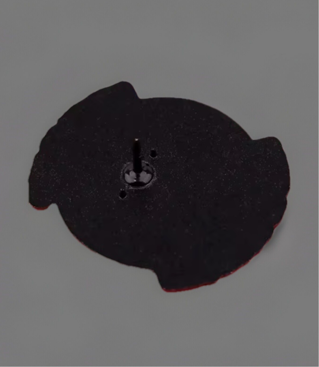 Back view of a doctor enamel pin showing black metal backing and pin clasp