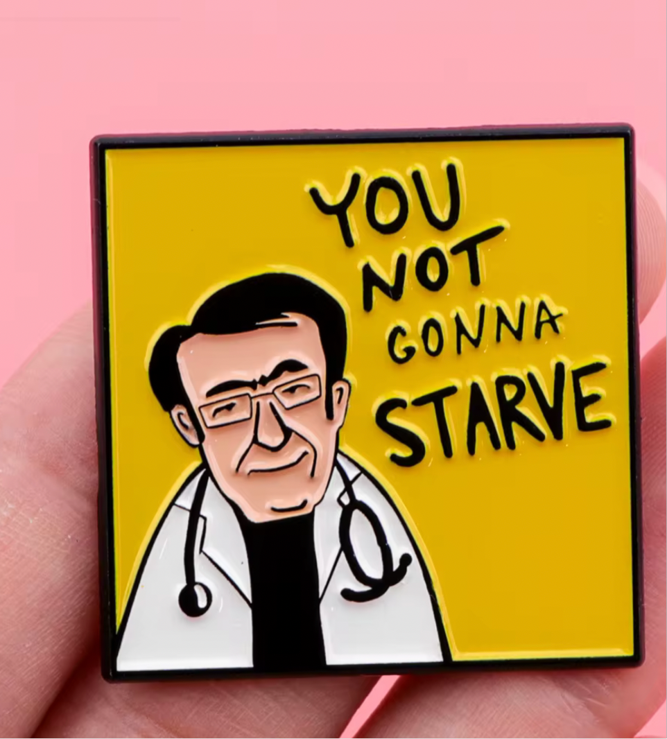 Doctor enamel pin with a smiling doctor and text you not gonna starve on yellow background