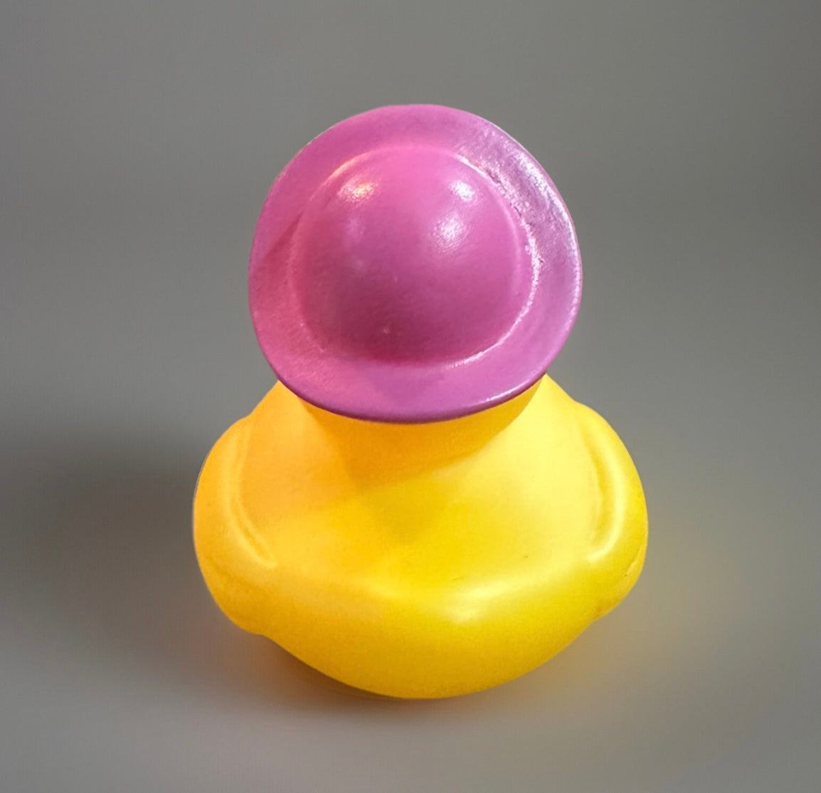 Yellow rubber duck wearing a pink hat Easter basket rubber duck from Reed’s Rubber Ducks and Sensory Shop