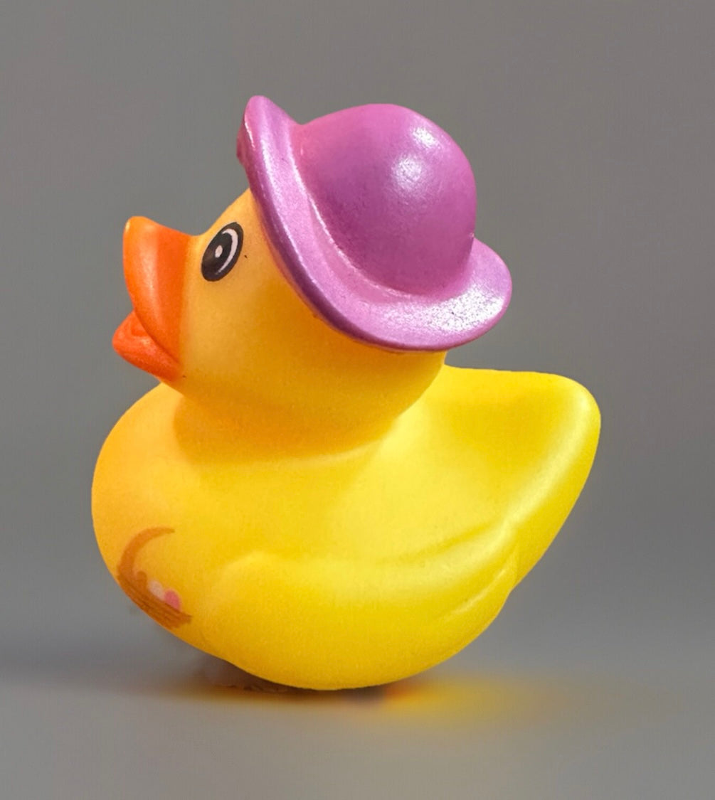 Yellow Easter basket rubber duck wearing a purple hat from Reeds Rubber Ducks and Sensory Shop