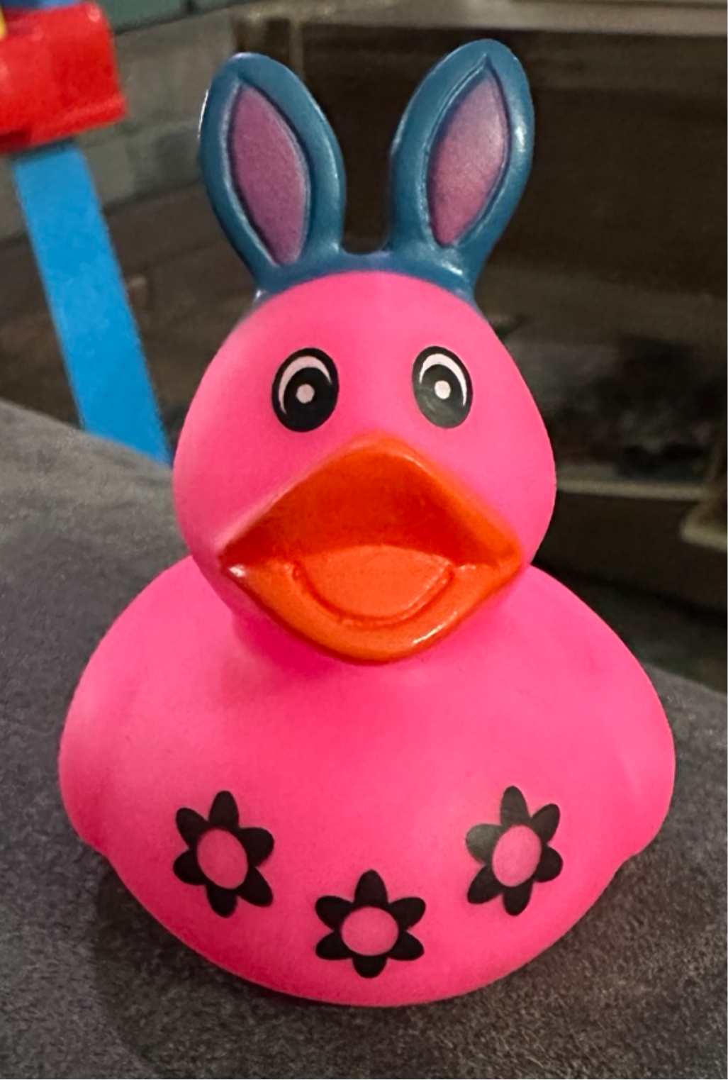 Cute pink Easter bunny rubber duck with flower designs and cheerful expression for Easter celebrations