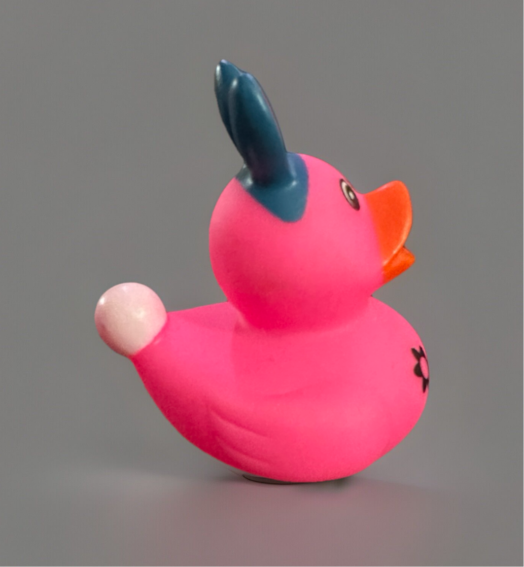 Vibrant pink Easter bunny rubber duck with blue ears and cute details for festive celebrations