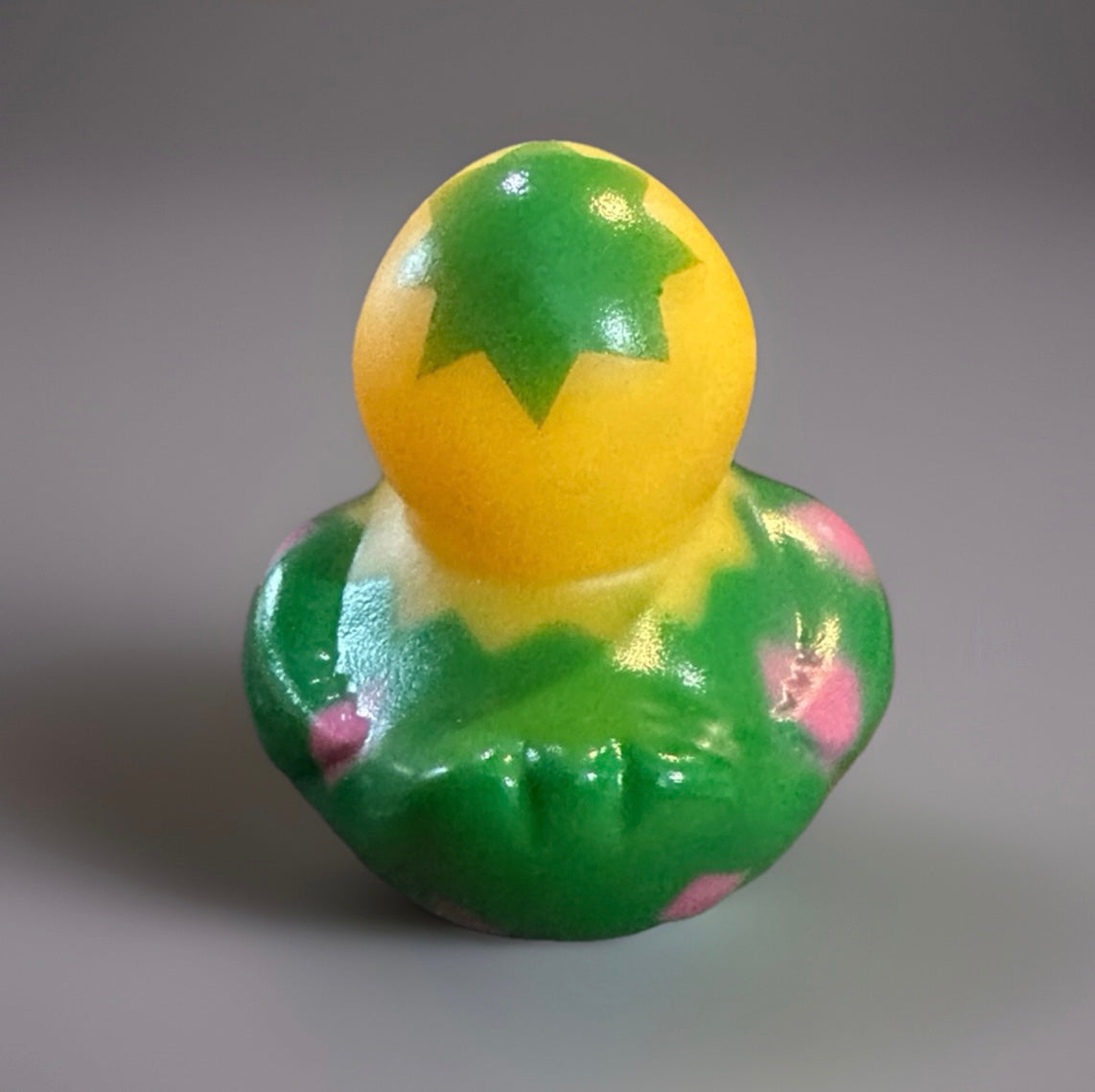 Easter egg rubber duck with yellow head and green body featuring pink and green leaf patterns