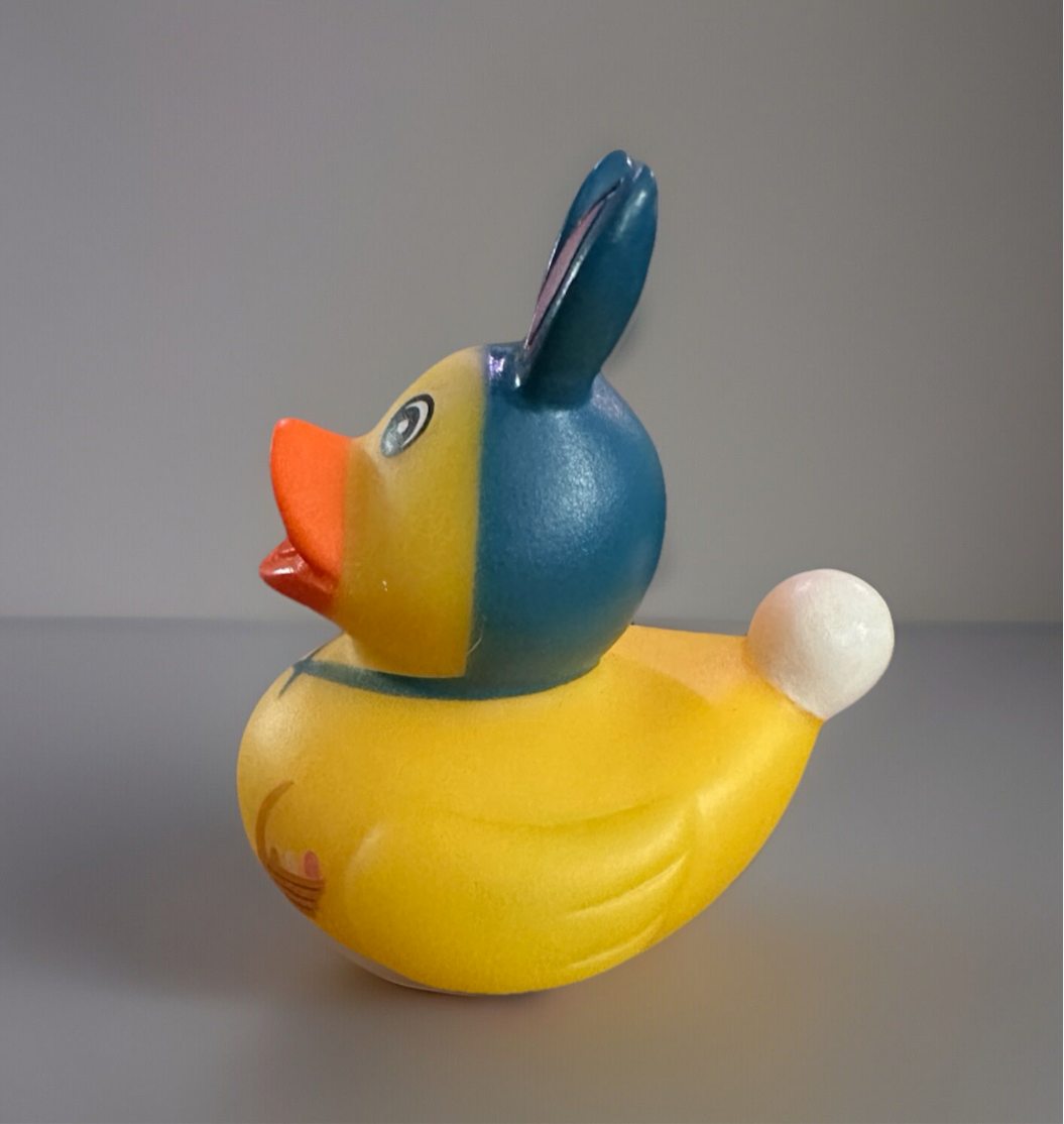 Colorful Easter rubber duck collectibles with bunny ears and a cheerful face for festive celebrations