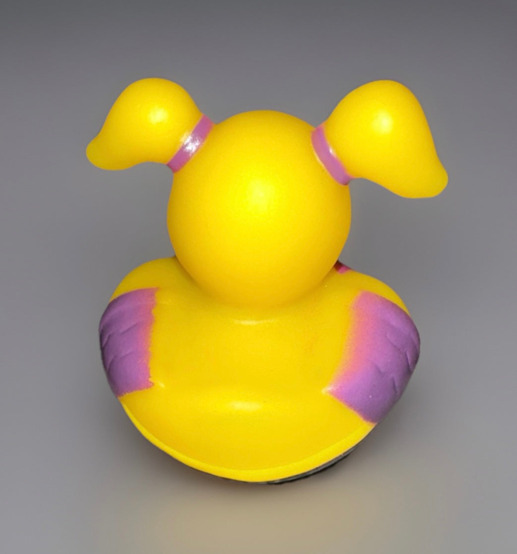 Yellow girl superhero rubber duck with purple gloves and pigtail hairstyle from Reed’s Rubber Ducks