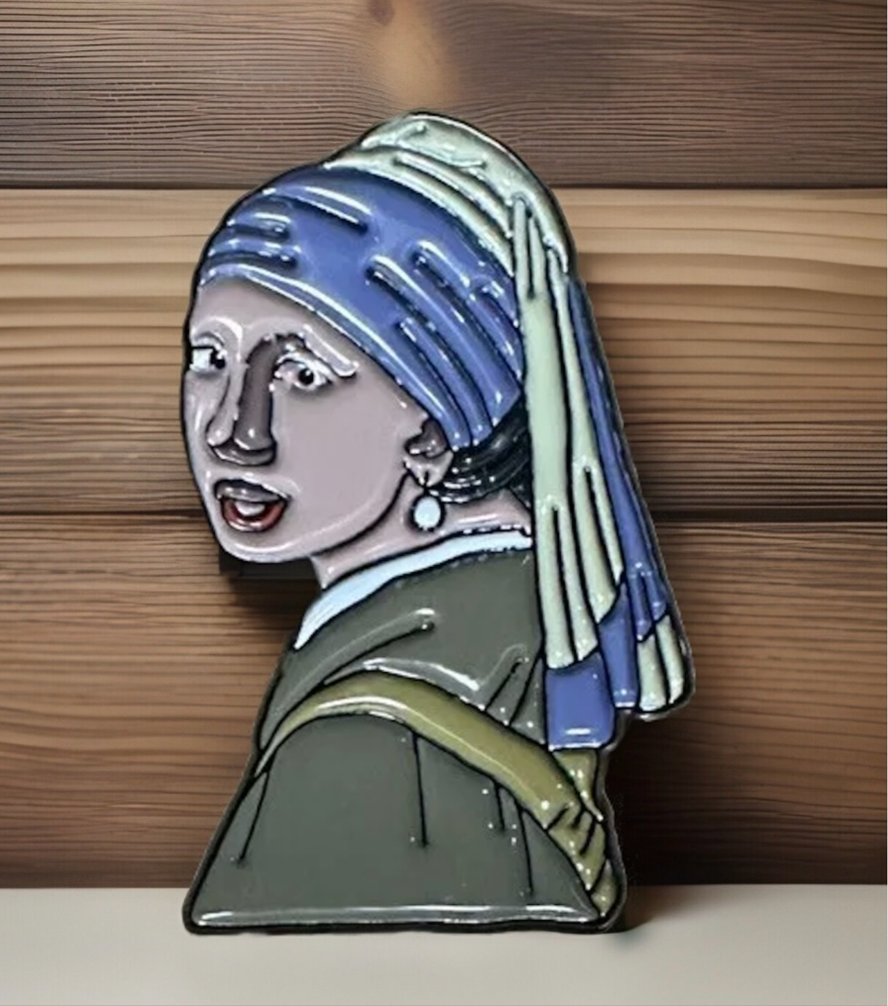 Girl With A Pearl Earring pin featuring a stylized enamel design with blue headscarf and pearl earring