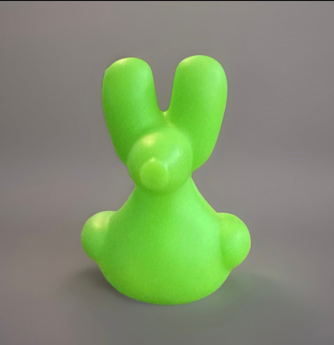 Bright green balloon animal rubber duck with a smooth texture from Reed’s Rubber Ducks and Sensory Shop