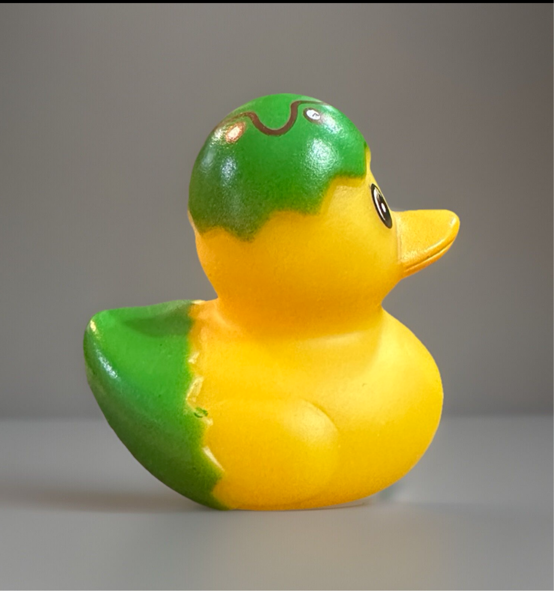 Green Easter egg rubber duck with yellow body and playful design for festive celebrations