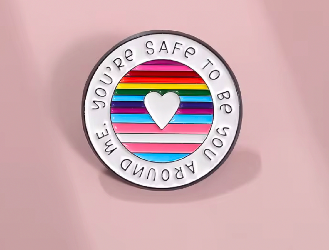 Inclusive enamel lapel pin featuring a vibrant rainbow design with a heart and supportive message