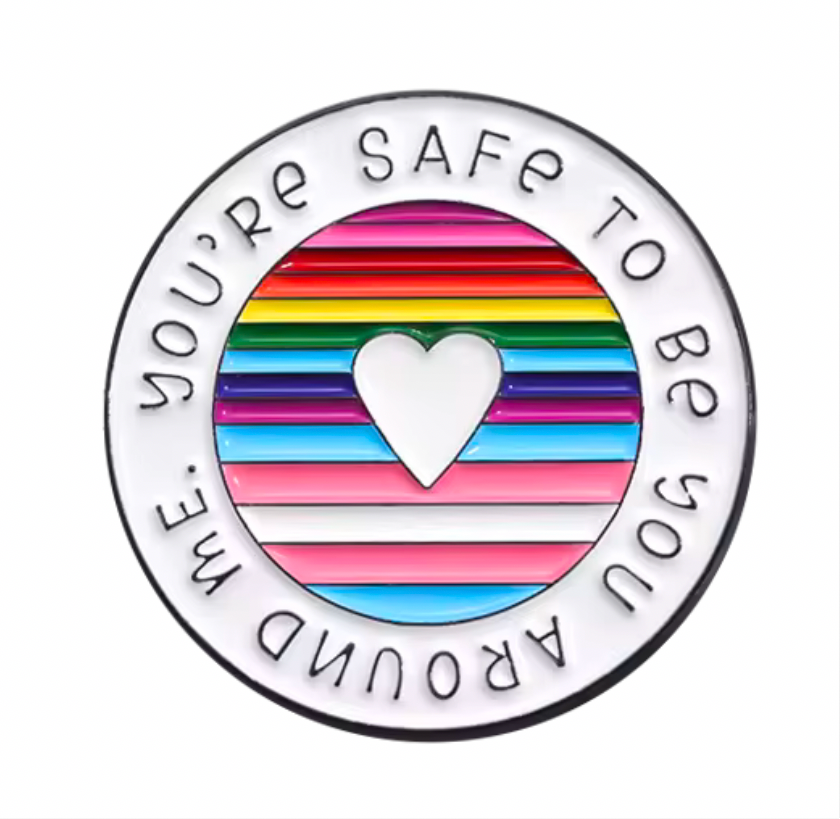 Inclusive enamel lapel pin featuring a heart with rainbow stripes and supportive message