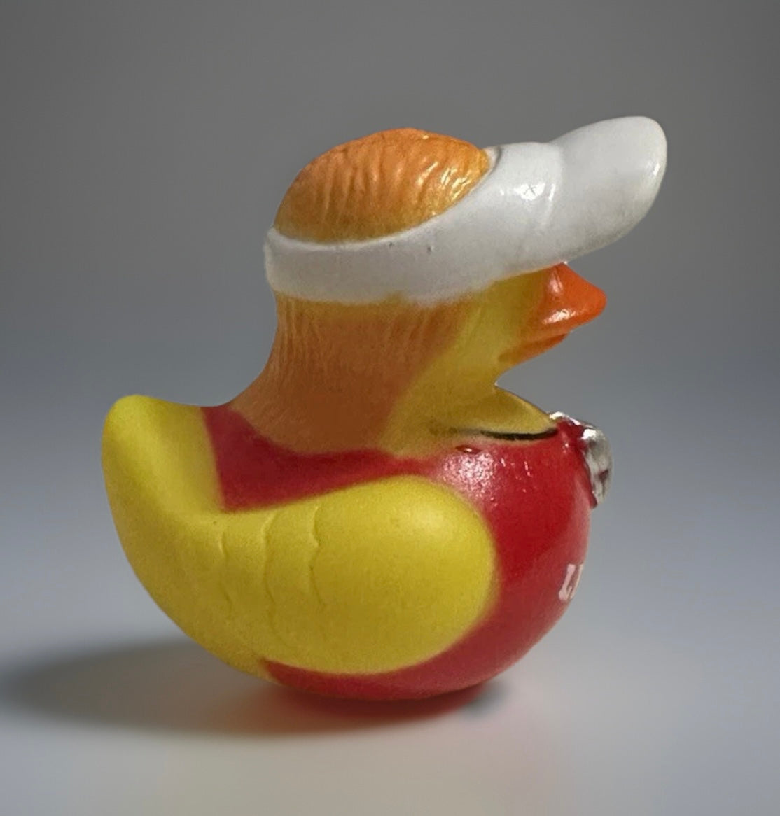 Lifeguard rubber duck wearing a white visor and red lifeguard outfit by Reed’s Rubber Ducks and Sensory Shop