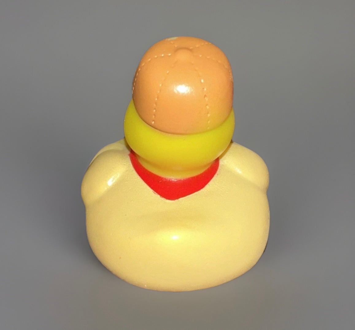 Back view of a park ranger rubber duck wearing an orange hat and red neckerchief