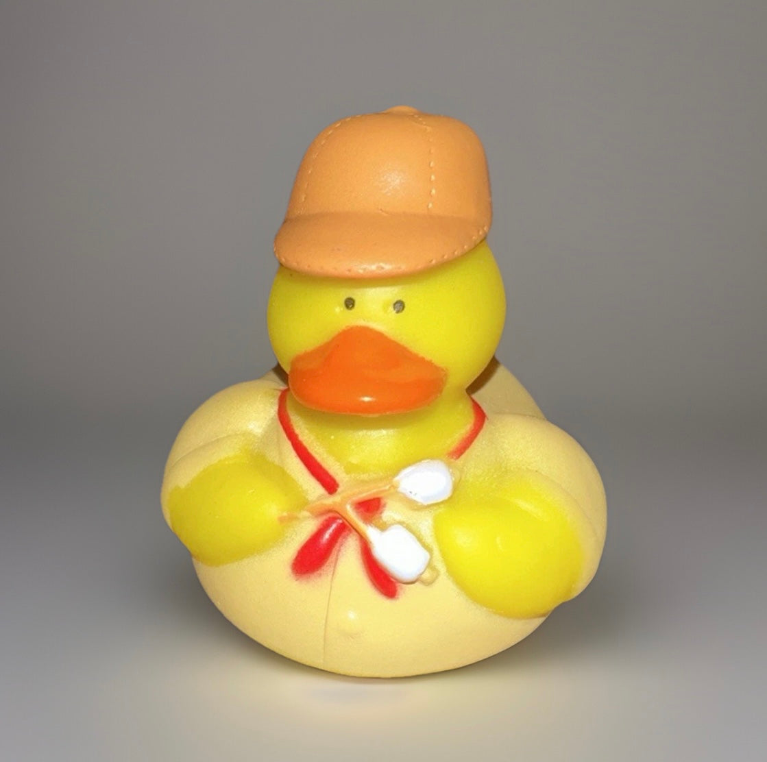 Yellow park ranger rubber duck wearing a tan hat and holding marshmallows on sticks