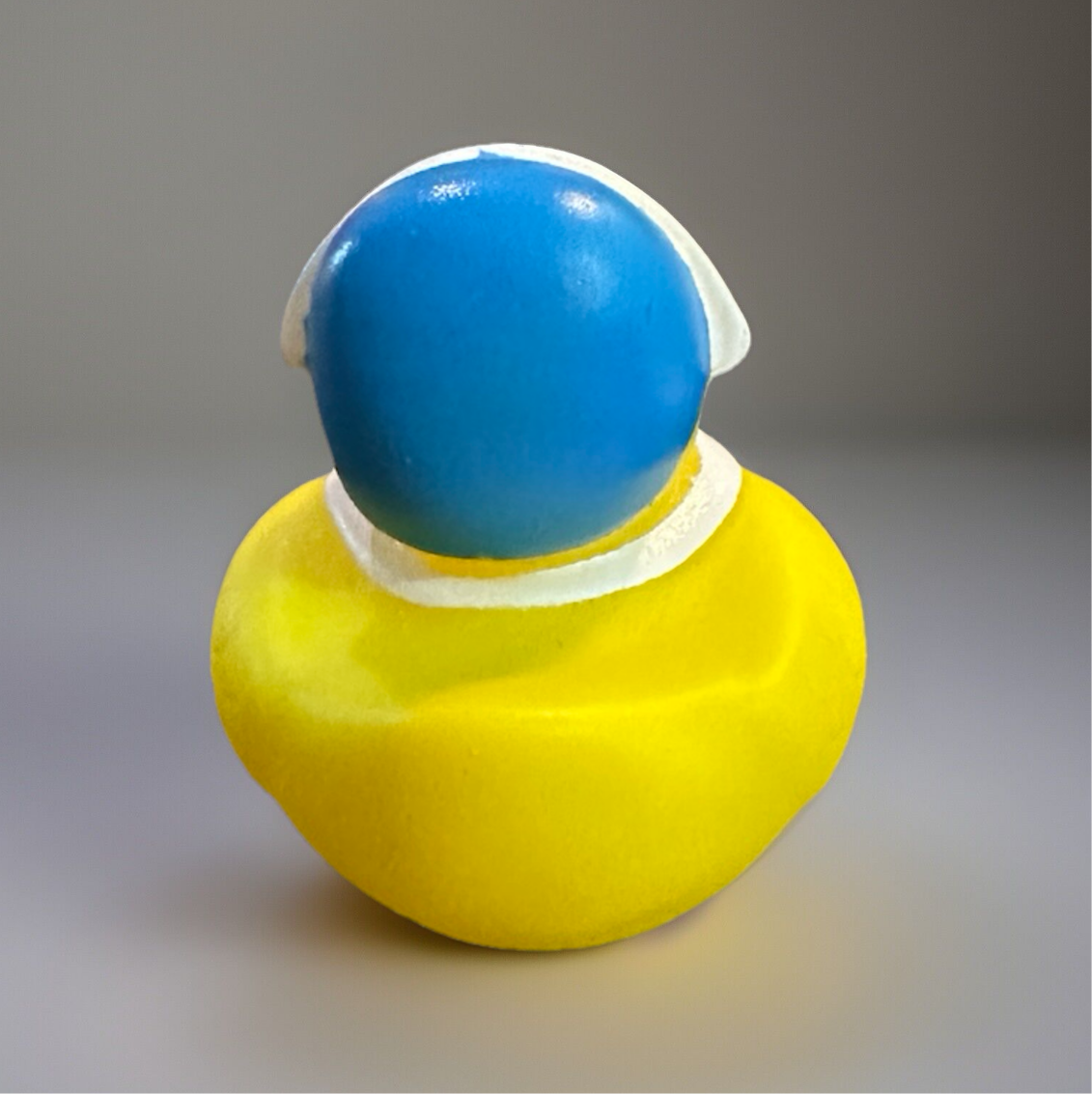 Colorful Pilgrim themed duck toy in yellow and blue, perfect for sensory play and Thanksgiving celebrations