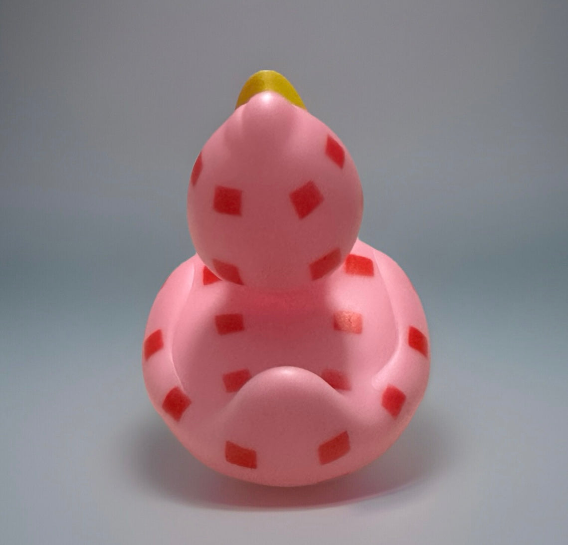 Pink checkered rubber duck from Reed’s Rubber Ducks and Sensory Shop with red squares and yellow beak