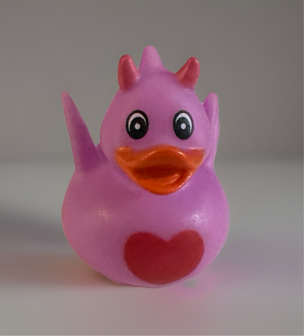Pink heart dragon rubber duck with orange beak and red heart on chest from Reed’s Rubber Ducks and Sensory Shop