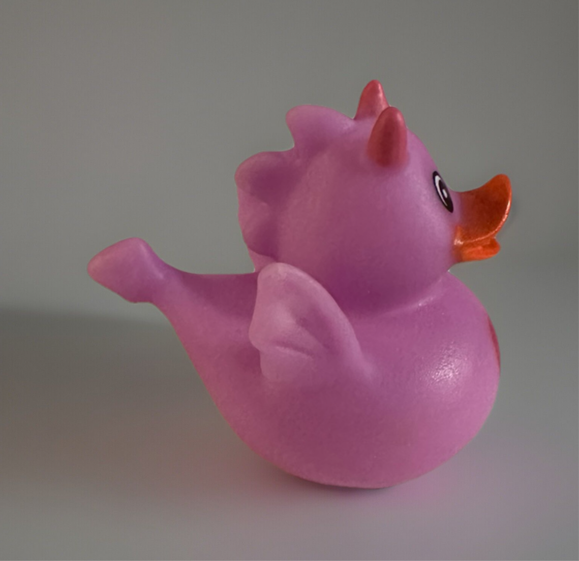 Pink heart dragon rubber duck with orange beak and small wings from Reed’s Rubber Ducks and Sensory Shop