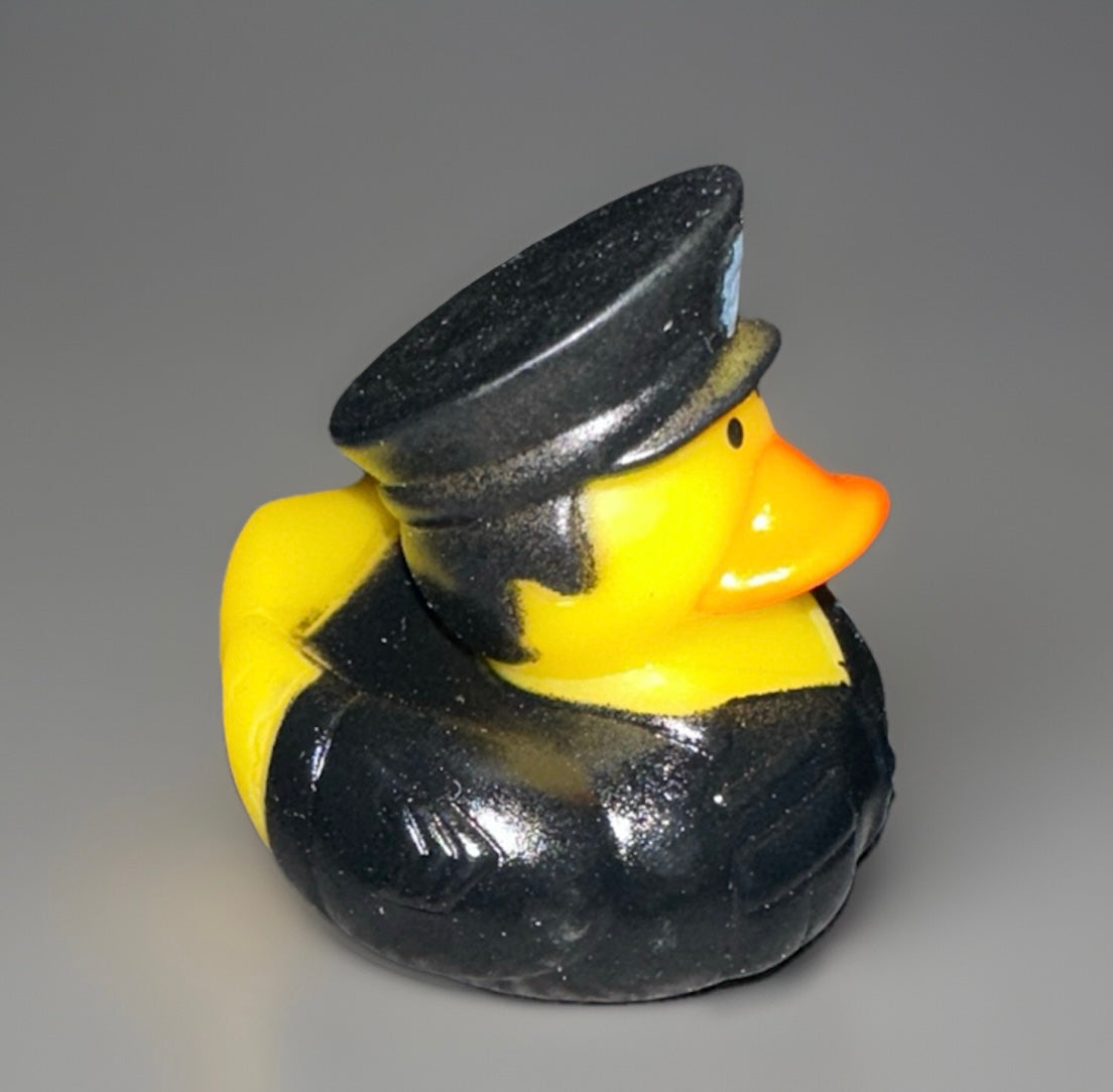 Yellow police rubber duck dressed in black uniform and hat from Reed’s Rubber Ducks and Sensory Shop