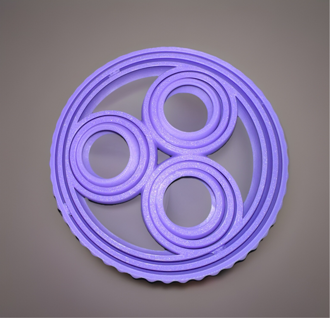 Purple 3D rotating fidget ring with multiple circular layers for stress relief and sensory play