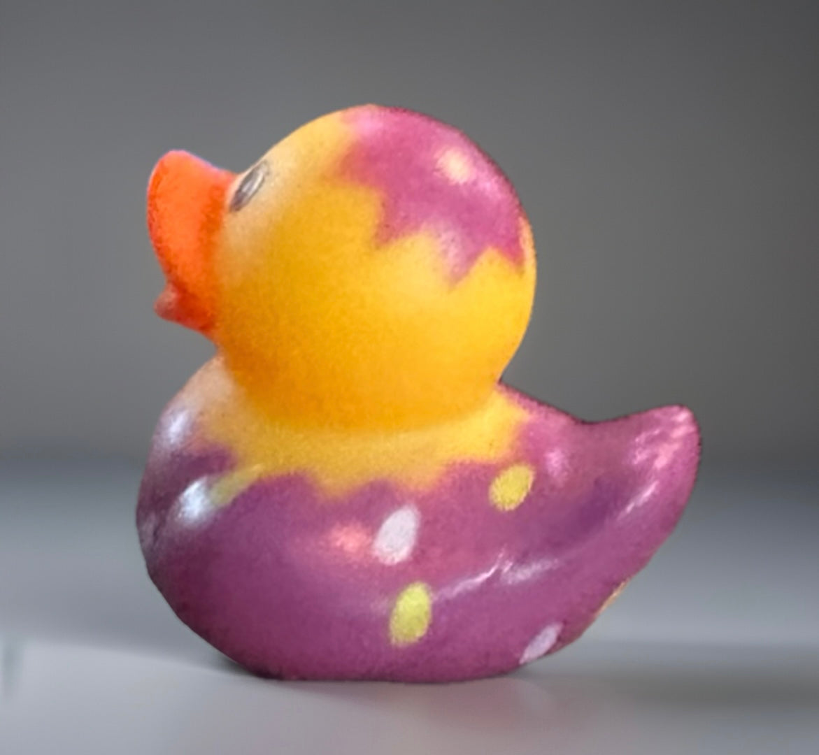 Purple Easter egg rubber duck with yellow and orange accents from Reed’s Rubber Ducks and Sensory Shop