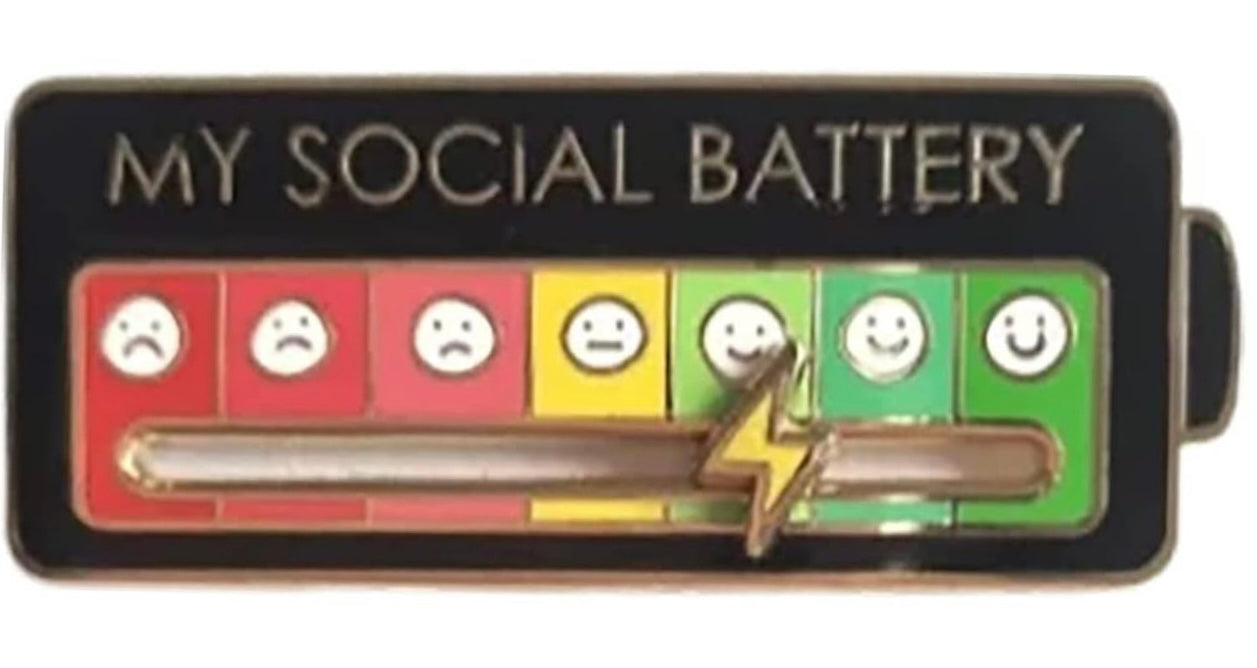 My social battery lapel pin showing emotional faces from sad to happy with a lightning bolt slider