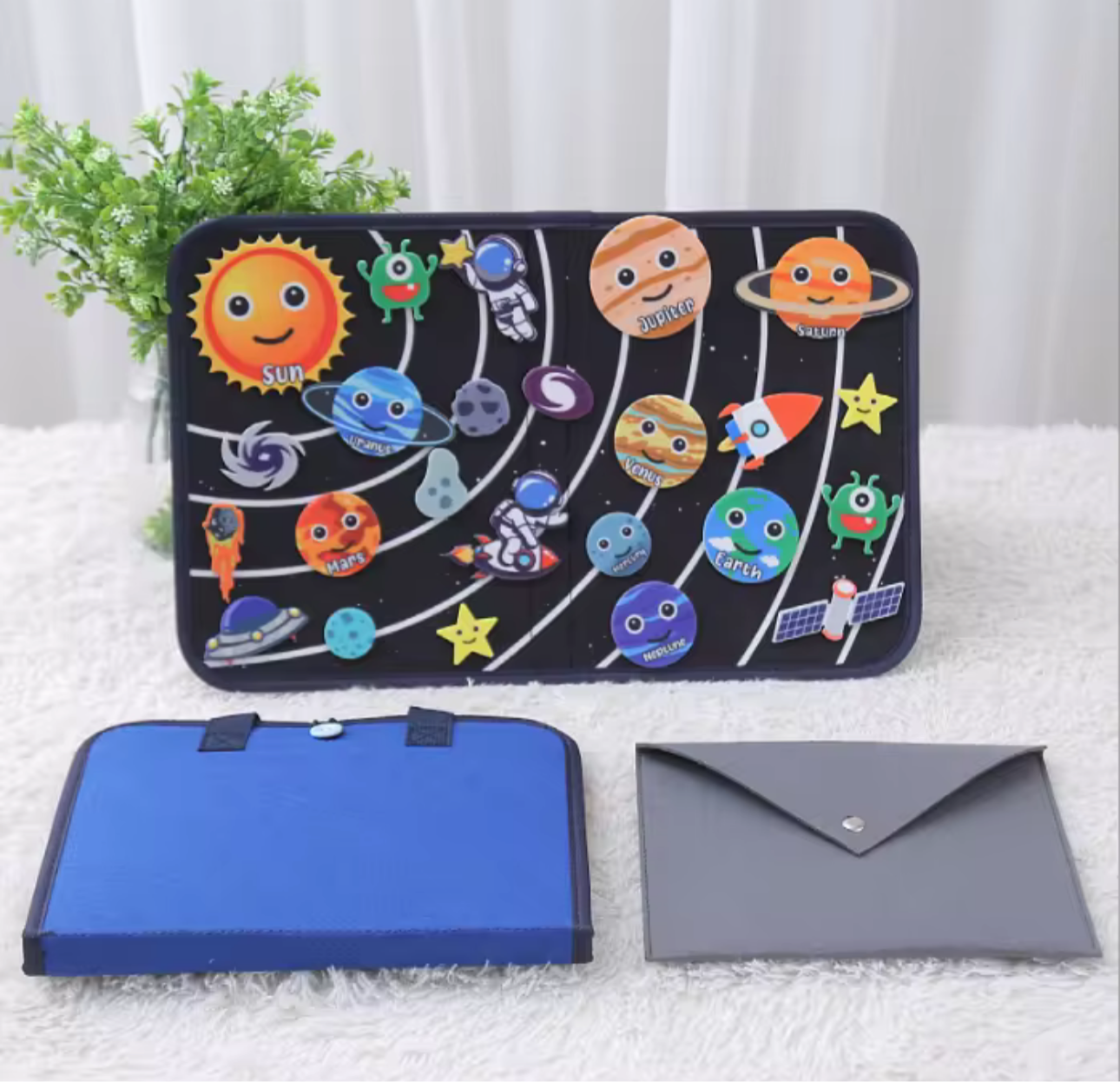 Space Montessori busy board featuring solar system planets and space-themed elements with blue and gray carrying cases