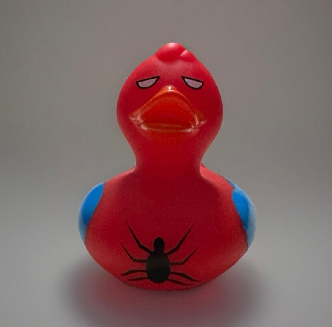 Red Spider Man rubber duck with black spider design and blue accents from Reed’s Rubber Ducks and Sensory Shop