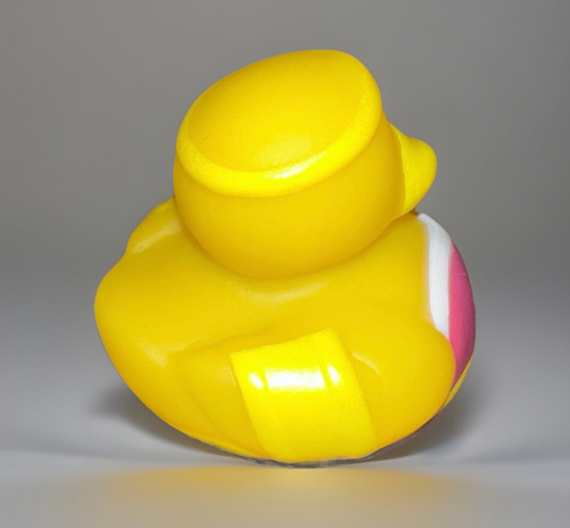 Yellow superhero girl rubber duck toy with a pink and white outfit from Reed’s Rubber Ducks and Sensory Shop