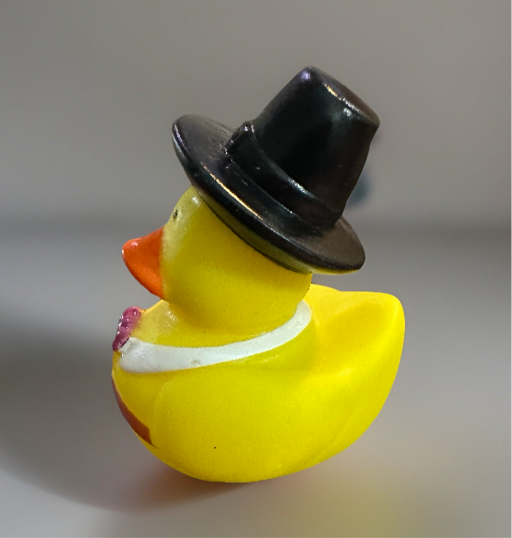 Thanksgiving rubber duck collectible wearing a black hat and white collar for festive decor