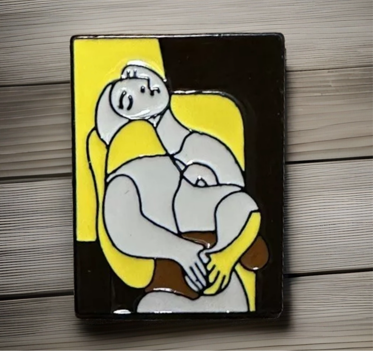 The Dream lapel pin featuring abstract art design in yellow, black, gray, and brown colors