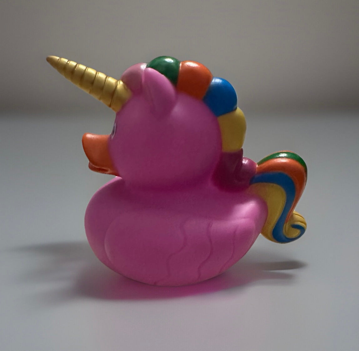 Pink unicorn rubber duck with golden horn and rainbow mane from Reed’s Rubber Ducks and Sensory Shop