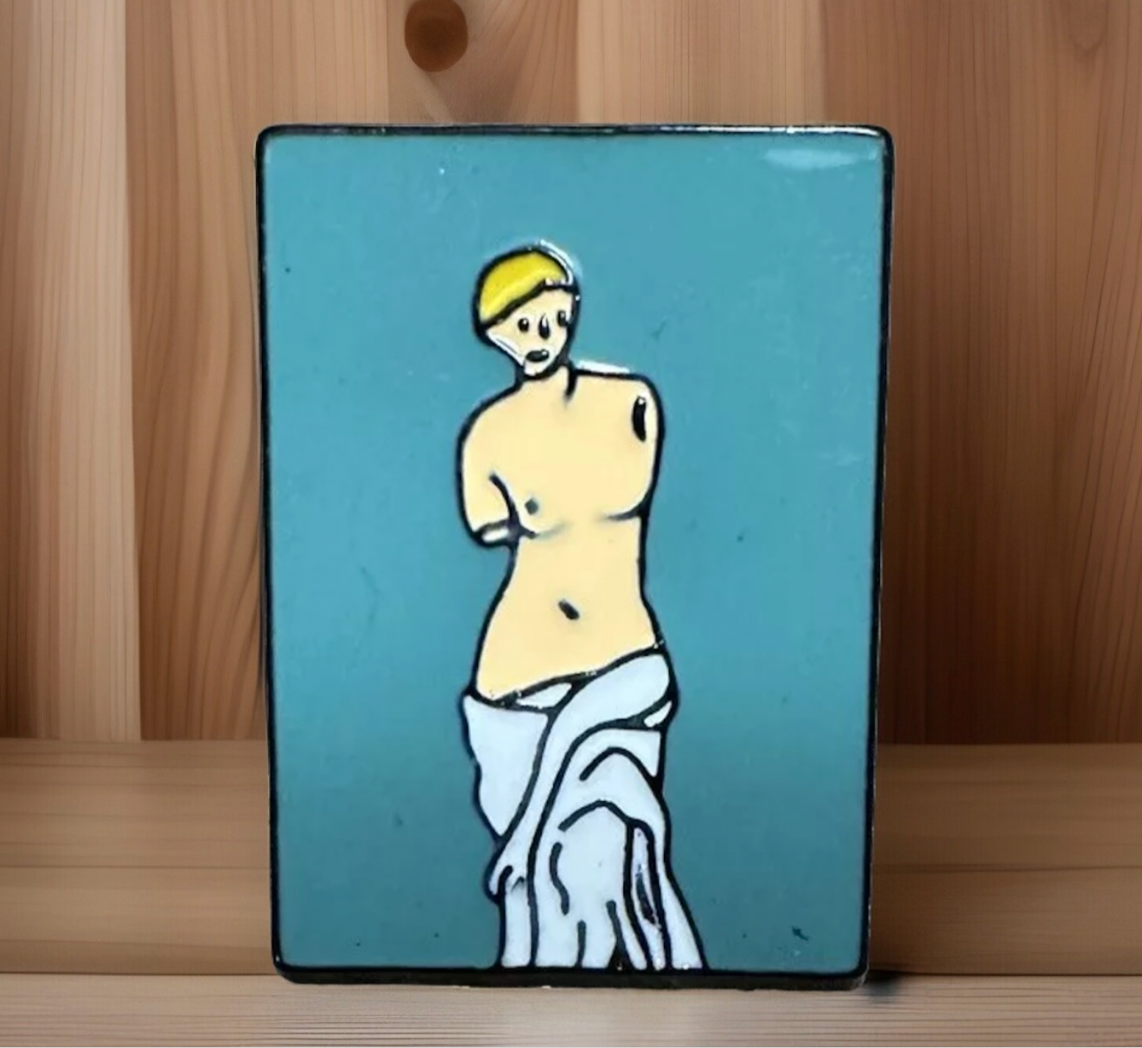 Venus De Milo enamel pin with minimalist design on turquoise background from Reed’s Rubber Ducks and Sensory Shop