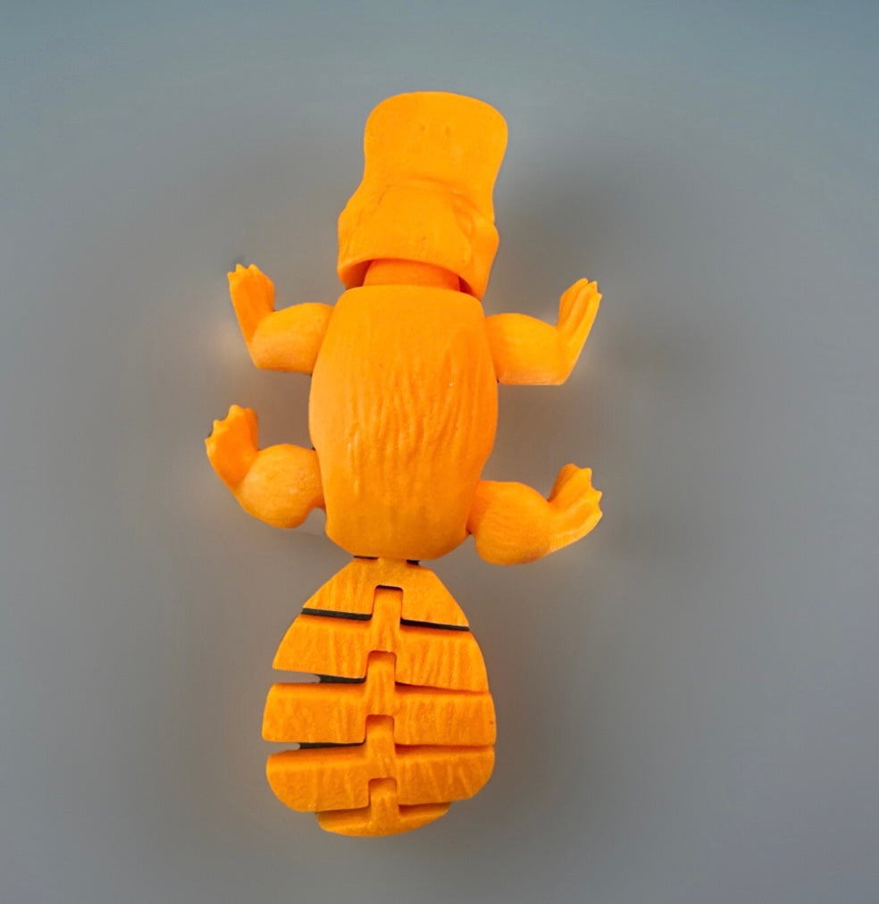 Bright orange 3D articulated fidget platypus toy with movable limbs and tail for sensory play