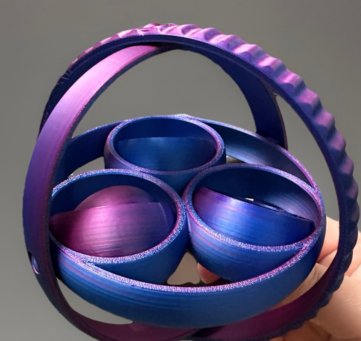 Reed’s Rubber Ducks and Sensory Shop 3D fidget rings for sensory relief in purple and blue held in hand