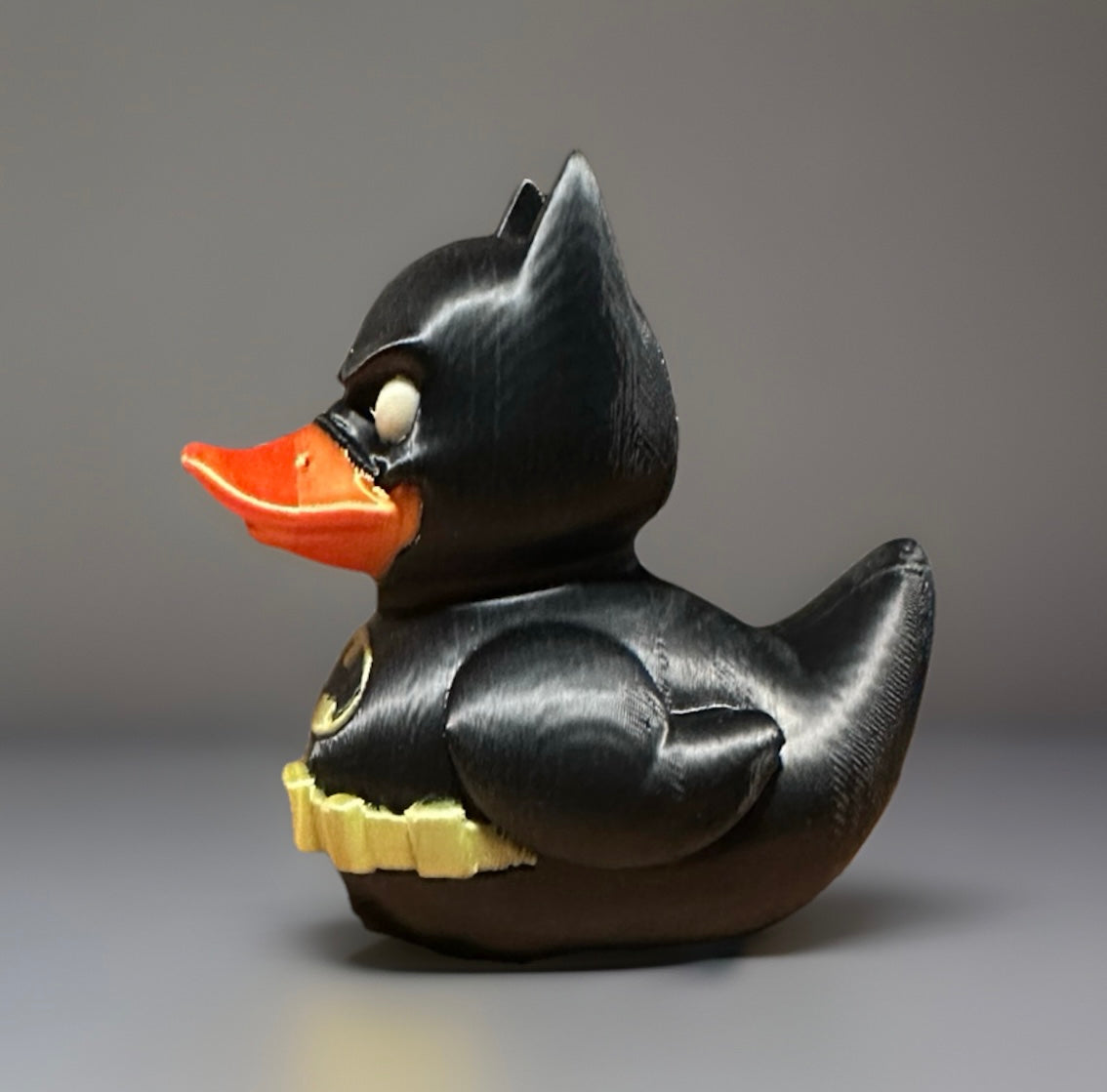 3D printed Batman duck with black suit and orange beak from Reed’s Rubber Ducks and Sensory Shop