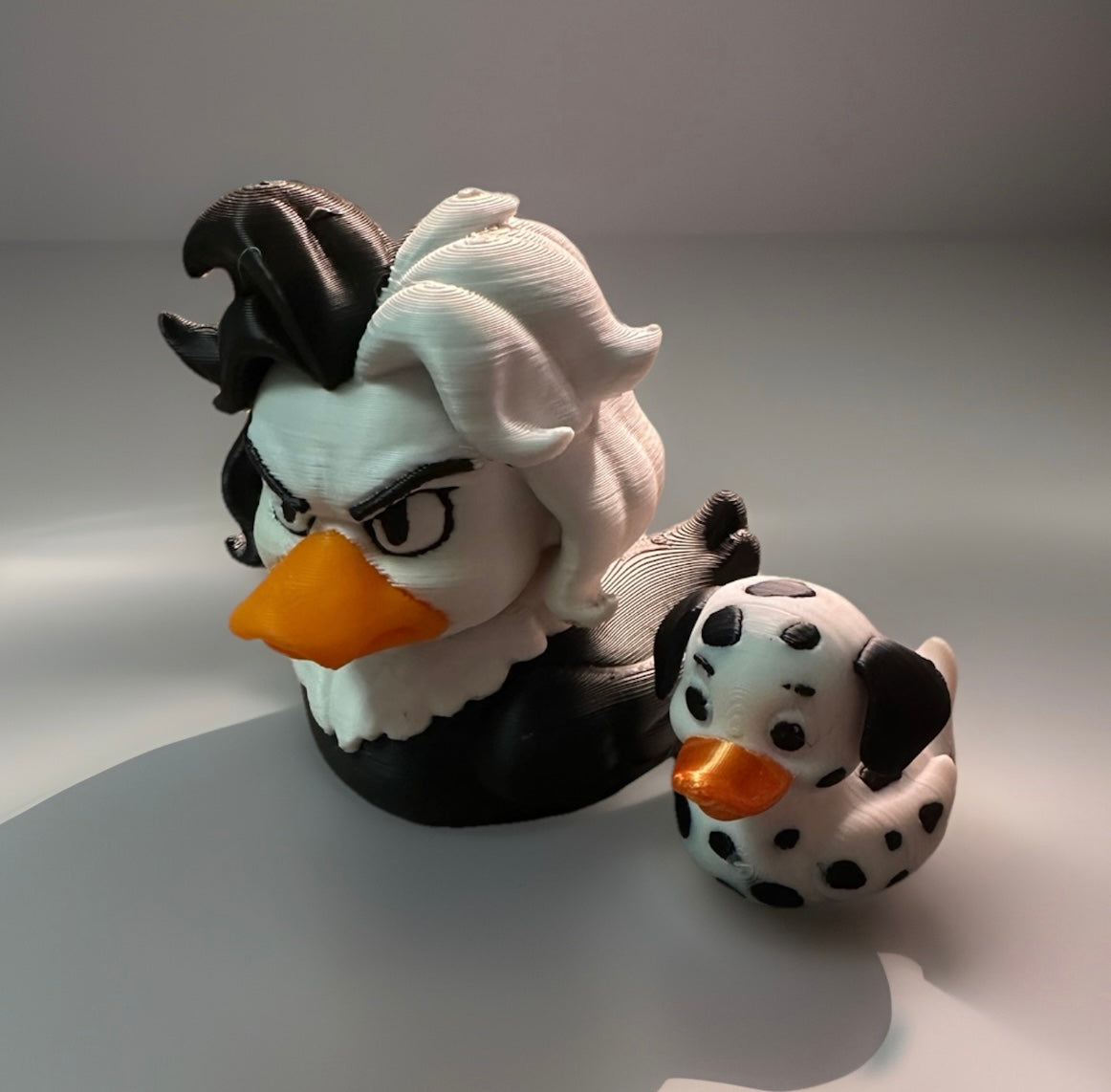 3D printed Cruella duck and Dalmatian with detailed black and white design and orange beaks
