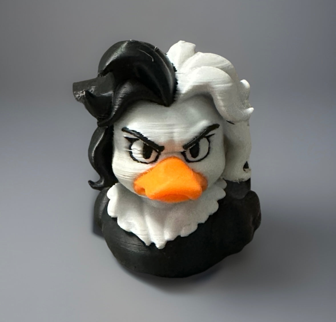 3D printed Cruella duck with black and white hair and orange beak by Reeds Rubber Ducks and Sensory Shop