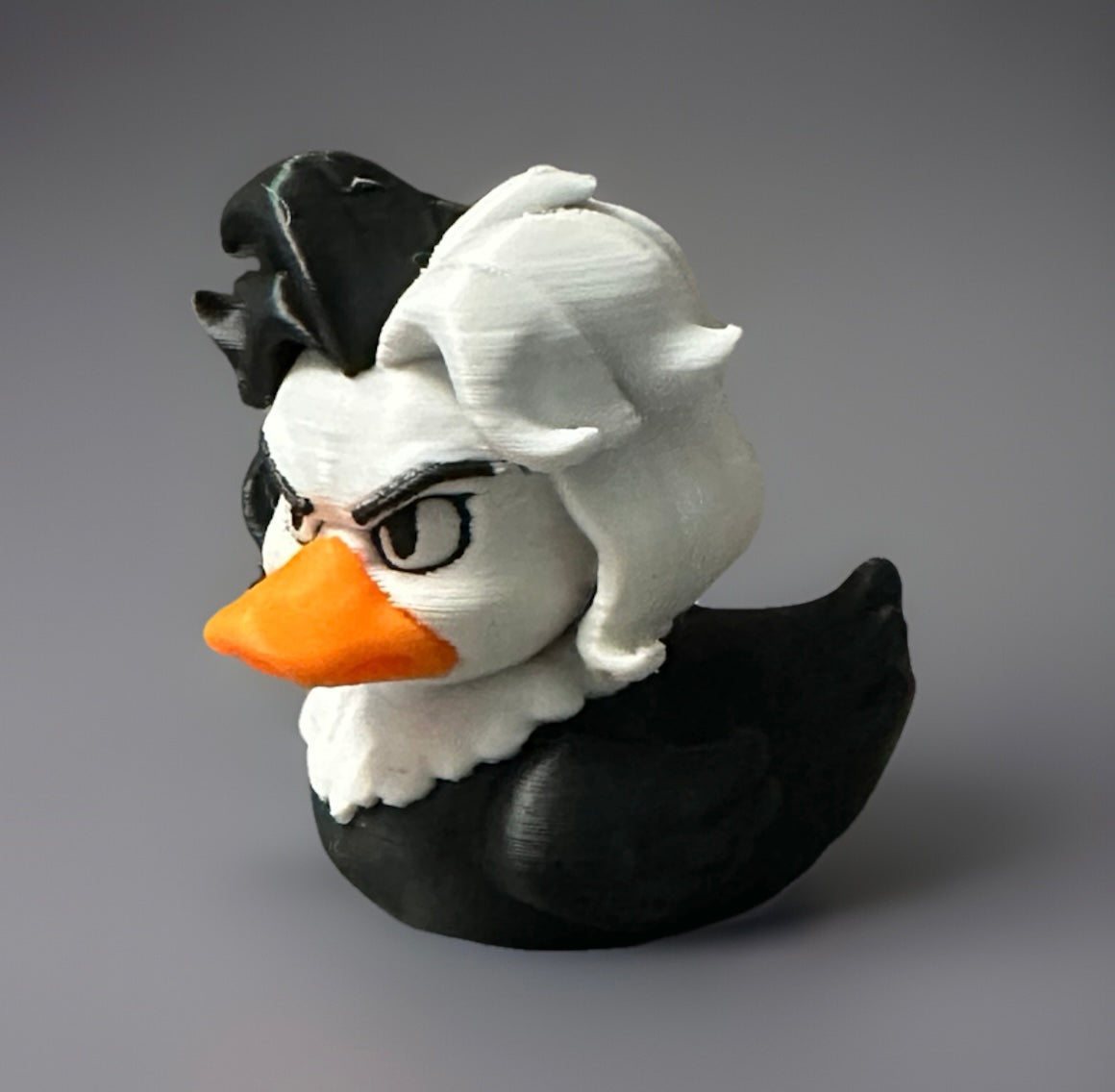 3D printed Cruella duck with black and white hair and orange beak from Reed’s Rubber Ducks and Sensory Shop