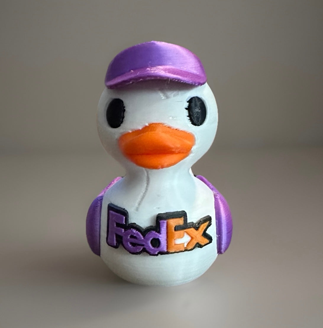 3D printed FedEx duck with orange beak purple hat and FedEx logo on front