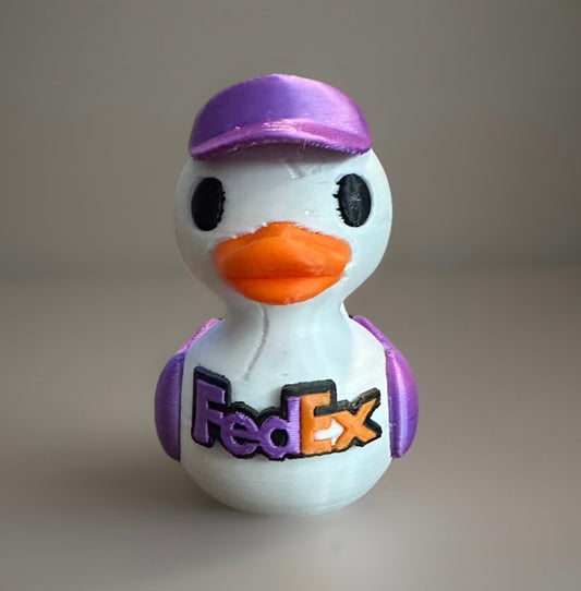 3D printed FedEx duck with orange beak purple hat and FedEx logo on front