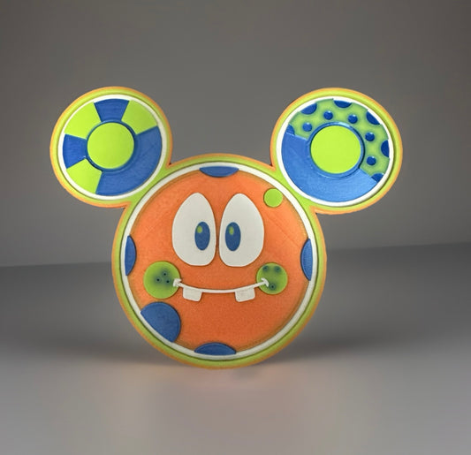 3D printed Oh Goofles collectible with bright orange face and blue green patterned ears
